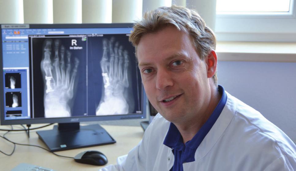 Dr. Wanja Wenk vor Beispielen aus der Praxis. Hier: die Korrektur eines schweren Hallux valgus